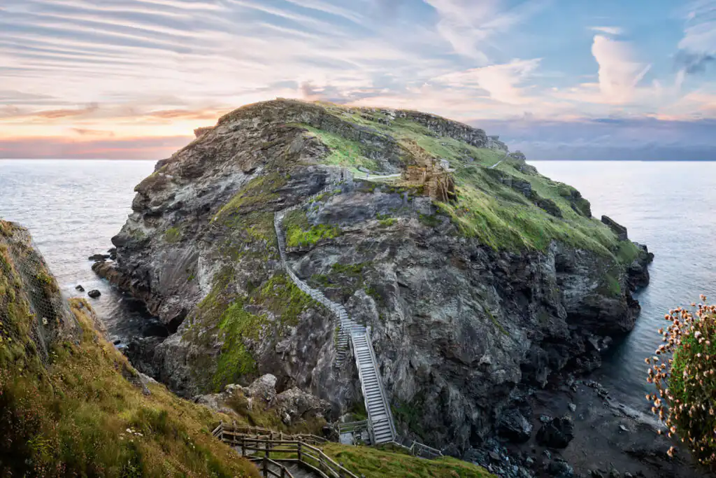 Peninsula of Tintagel Island and legendary castle ruins at sunset