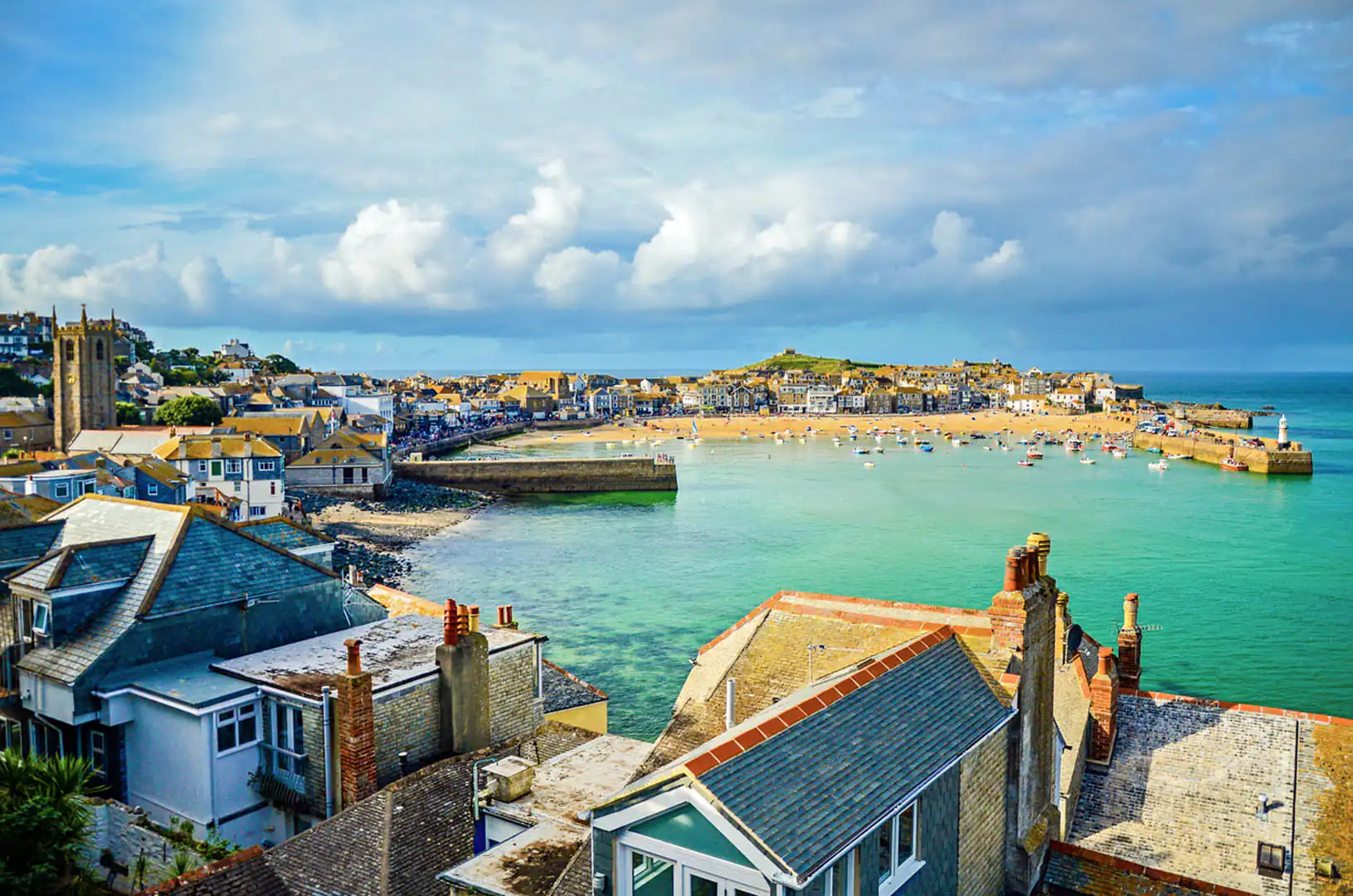 Scenic view of St Ives Harbour with a cloudy sky, home to a few a new Cornish Escapes Holiday Cottages.